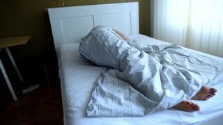 Girl's bare feet in bed